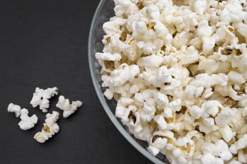 bowl full of popcorn on black background