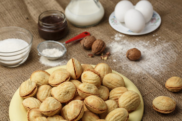 homemade cookies shaped nuts with cream boiled condensed milk on sackcloth. Rustic style