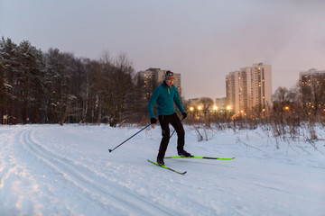 Picture of male skier in blue jacket in winter park