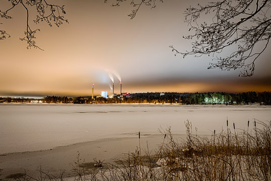 Night view for Swedish winter lake and Vaxjo city on horizon