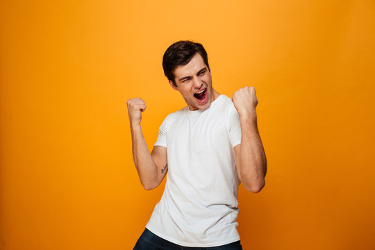 Image of Happy man in t-shirt rejoice with open mouth