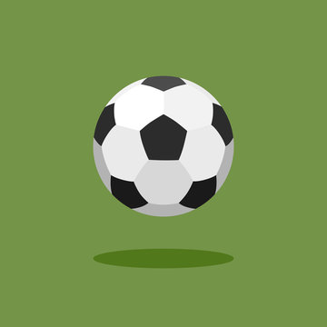 Classic soccer ball on green background