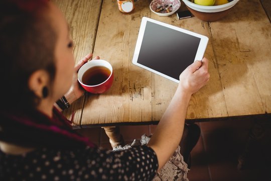 High angle view of young woman using digital tablet
