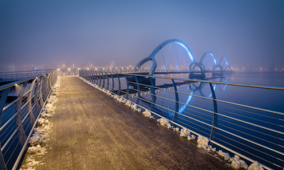 Colorfull Solversborgs pedestrian bridge in foggy scenery