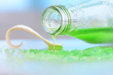 Green liquid spilling out of a bottle
