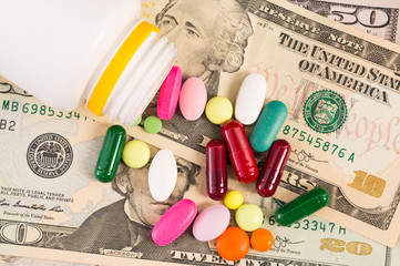 Bunch of pills on dollar bills