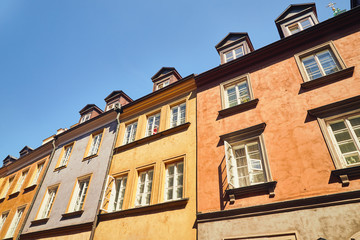 Facades of old town houses in Warsaw, Poland against the blue sky
