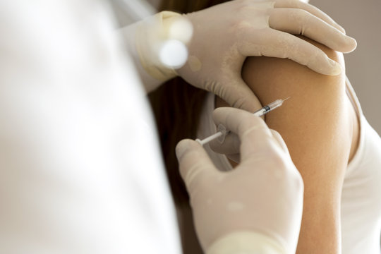 Doctor hand make patient insulin flu shot by syringe subcutaneous arm injection vaccination
