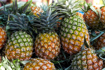 Pineapple background/ lots of ripe yellow pineapples/ market asia fruit food pineaple tomato vegetables street