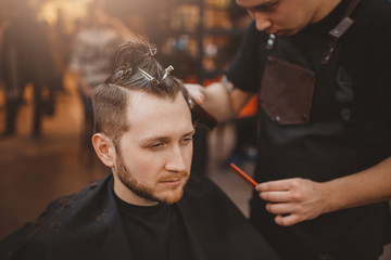 Barber shop. Customer man smiles and laughs during haircuts in Barbershop