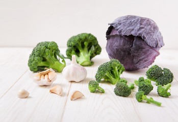 Fresh cabbage,broccoli and garlic.white wooden table.organic vegetables.
