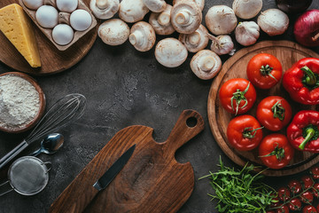 top view of different vegetable ingredients for pizza on concrete surface