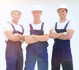 successful construction workers standing with arms crossed