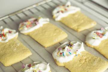 Cookies in the form of Easter cakes, decorated with whipped whites with a multicolored powder. Easter dishes and decorations. Holiday spring concept
