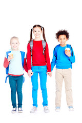 Obraz premium Portrait of three multi-ethnic school friends holding hands on white background