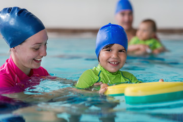 Little boy learning to swim