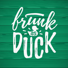 Frunk As Duck funny handdrawn dry brush style lettering on green wooden background, 17 March St. Patrick's Day celebration. Suitable for t-shirt, poster, etc.