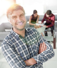 Smiling mature businessman in plaid shirt foreground