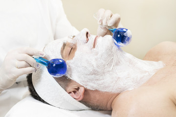 Man in the mask cosmetic procedure in spa salon. 