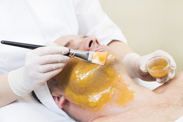 Man in the mask cosmetic procedure in spa salon. 