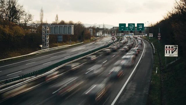 Time lapse of heavy flow of traffic on highway at the border between Switzerland and France.
