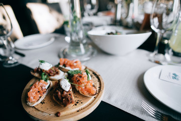 wedding snacks on a wooden tray on the table