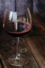 Glass of red wine on a wooden table   