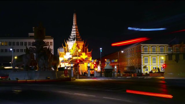 Bangkok, Thailand. Night car traffic in center of Bangkok, Thailand. Illuminated City Pillar Shrine. Time-lapse at night