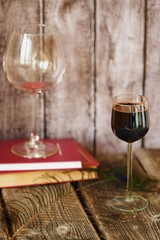 Glass of red wine on a wooden table   