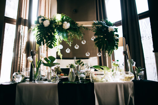 Beautiful dark Wedding table setting with fresh flowers decoration  and black table in the restaurant