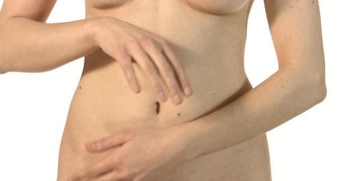 Close up of woman's hands rounding her belly isolated on white background.