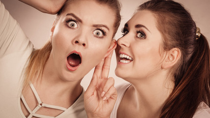 Two women telling gossip