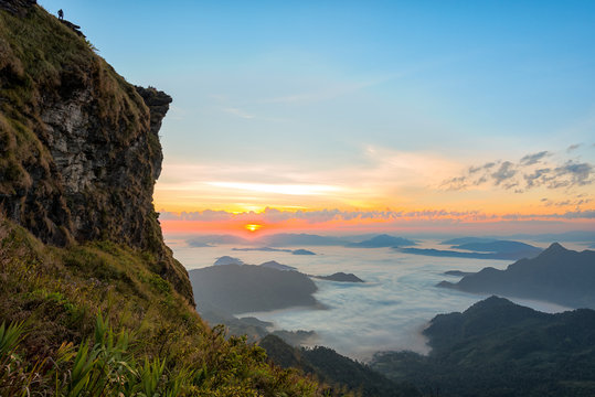 Mountain View With Morning Fog And Sunrise Scene With The Peak Of Mountain At Phu Chi Fa In Chiangrai,Thailand