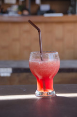 watermelon smoothie  on  table have direct sunrise on the glass