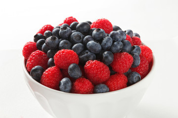 Close up of blueberries and raspberries on White Background
