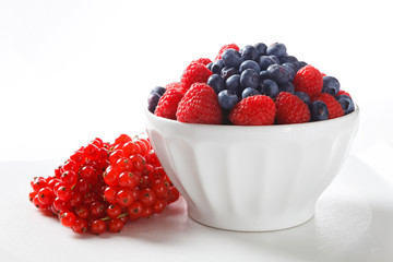 Fresh Berries in White Bowl on White Background