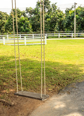 Empty wood swings on ropes  in the park
