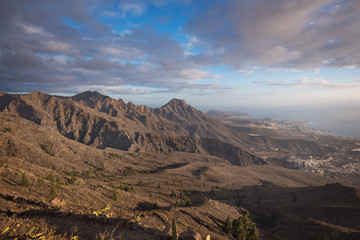 Tenerife mountain landscape. Trekking path. Adeje and Las Americas coastline in the background.