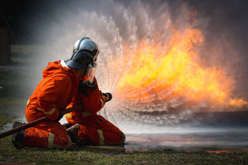 Firefighters training, Team practice to fighting with fire in emergency situation..Spray twist water to the flame