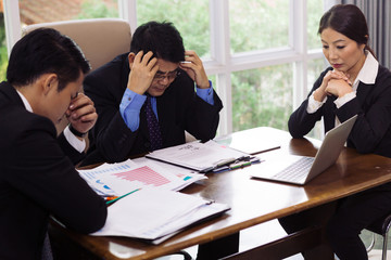 Asian business people team strain with their work on office desk