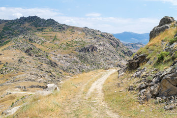 Fototapeta na wymiar Path through rugged and rocky terrain outside Prilep, Macedonia