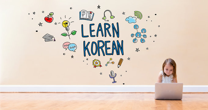 Learn Korean text with little girl using a laptop computer on floor