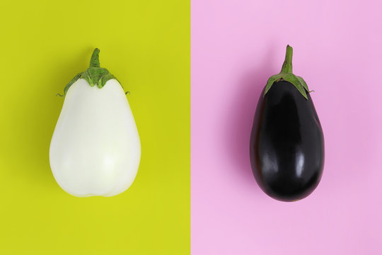 white and black eggplants isolated on green and pink background