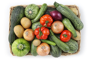 top view food zucchini with tomatoes, onion and potatoes in wicker, basket isolated on white background