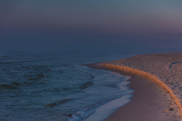 Beach during sunrise fog