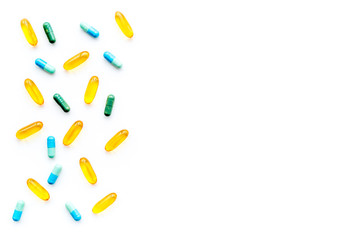 Color capsules. Medicine pills on white background top view copy space pattern