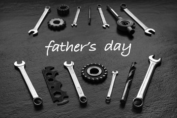 Fathers Day message with tool set. Black textured background.