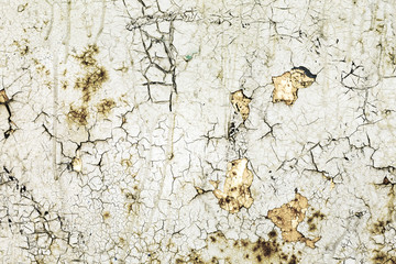 Painted wall with damaged paint and cracks