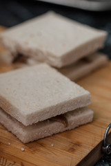 Two Toasts Bread with Anchoas on Wooden Board. Process of Preparation of Fried Pane Sandwiches. Cooking food.