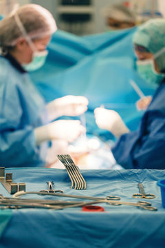 the surgeon team operates an open heart patient in a surgery room equipped with sterile instruments for cardiovascular emergency surgery interventions with clamps, forceps